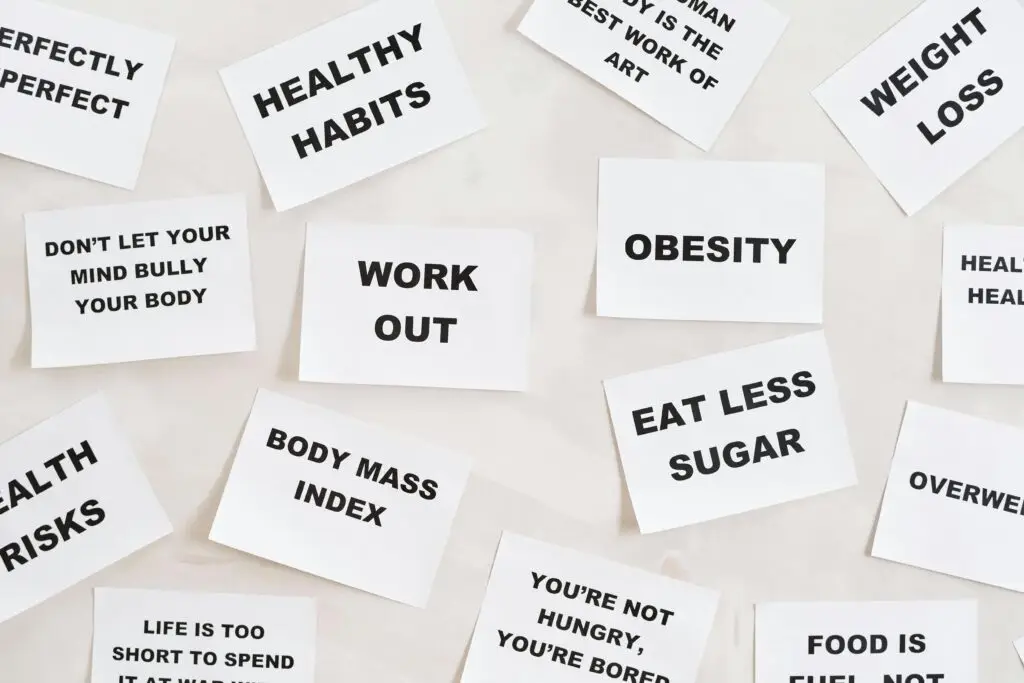 Collection of motivational quotes promoting health and wellness on paper cards.