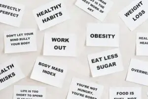 Collection of motivational quotes promoting health and wellness on paper cards.