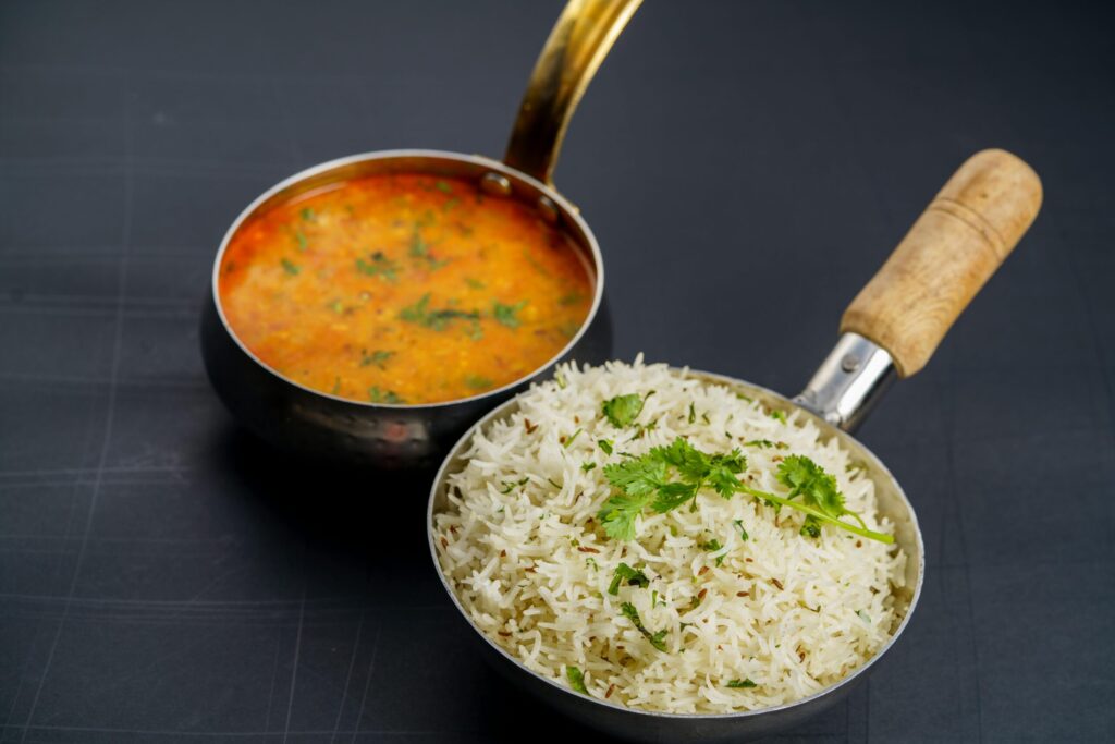 A top-down view of Indian rice with dal curry in pans. Perfect for authentic Indian cuisine themes.