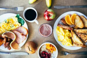 Vibrant breakfast with eggs, fruits, toast, and coffee for a wholesome start.