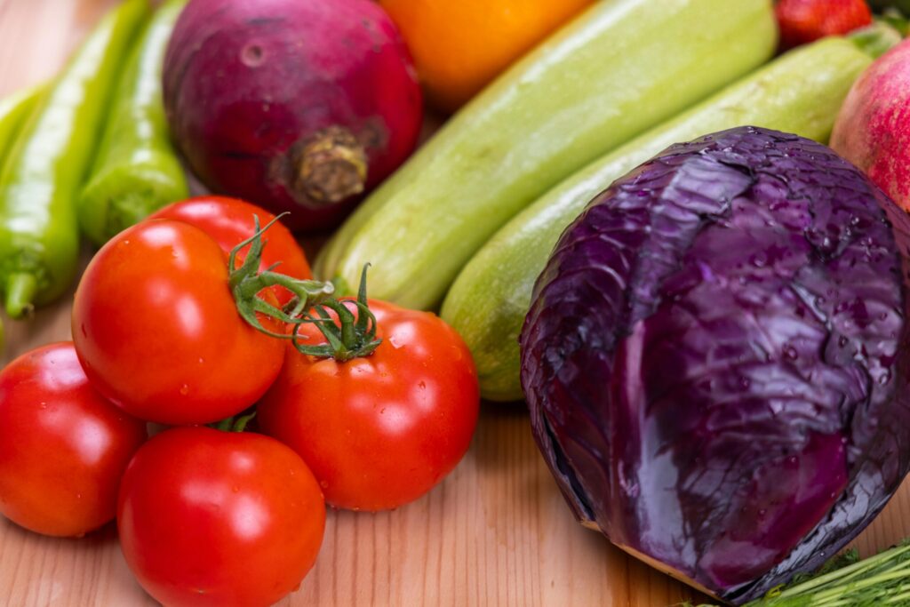 A vibrant assortment of fresh, organic vegetables on a wooden table, perfect for healthy eating.