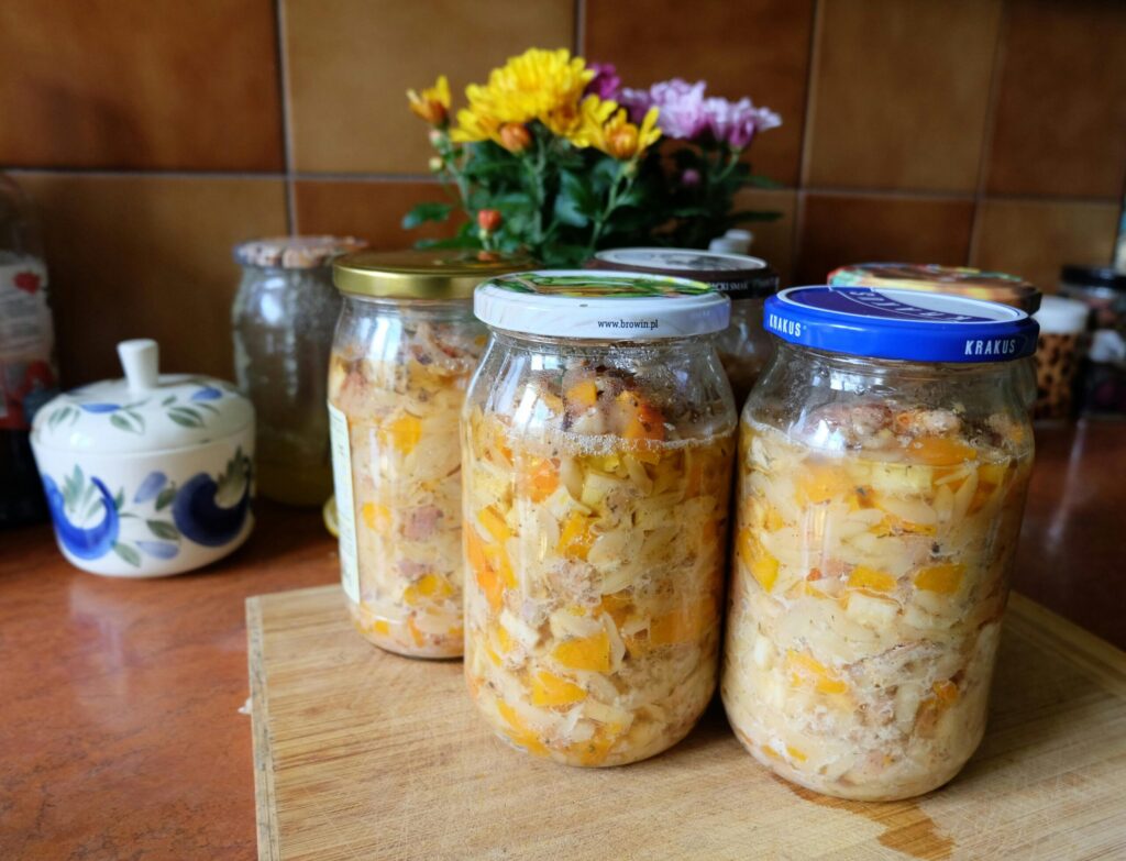 Colorful homemade pickled vegetables sealed in jars, displayed on a kitchen countertop.