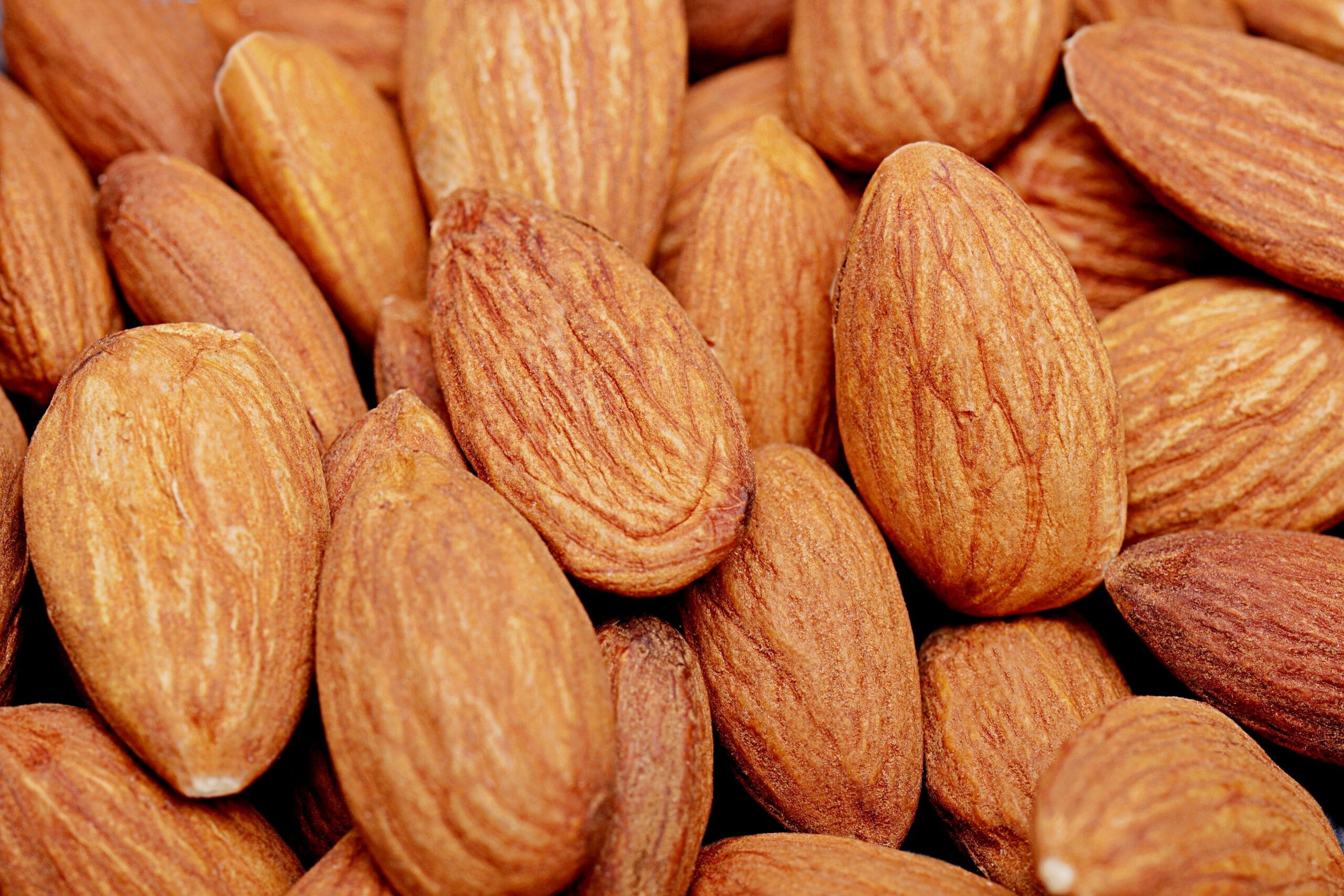 High-resolution close-up of raw organic almonds showcasing texture and natural color.