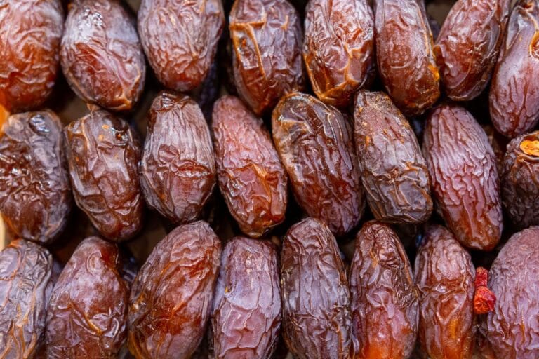 Detailed shot of fresh ripe dates in rows, ideal for food and health topics.