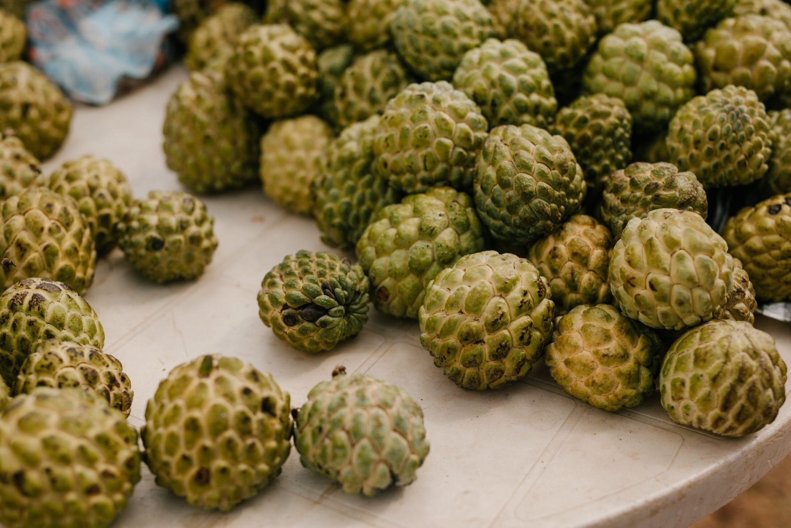 From above of stack of fresh ripe exotic globe artichokes placed on table in countryside